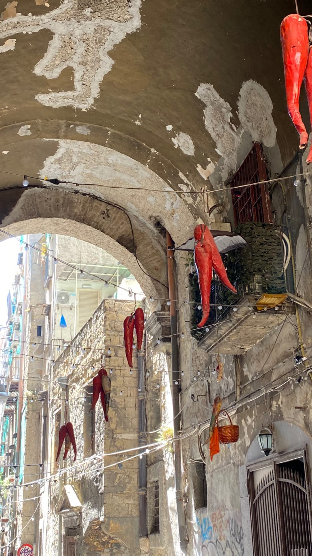 Giant red horn charms in Naples' old alleys