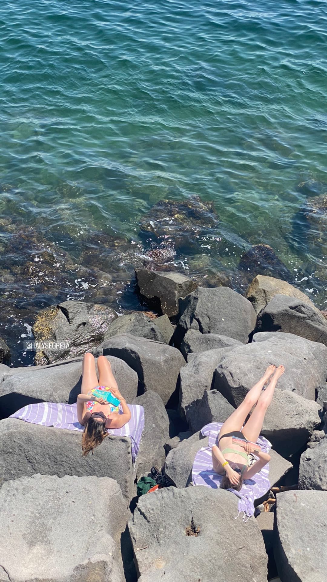 Sunbathing on the rocks in Naples