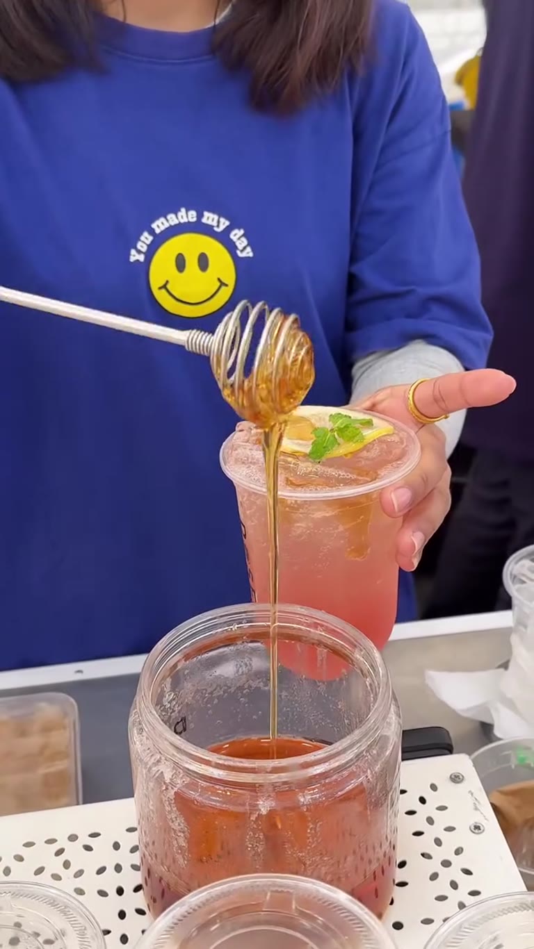 Honey-drizzled iced drinks at a Bangkok market stall