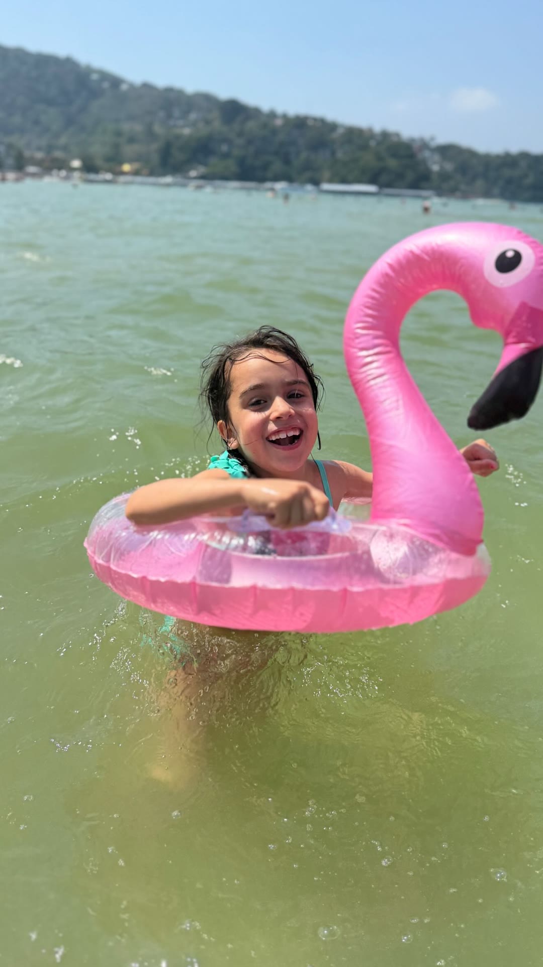 Kid swimming with a flamingo float in Phuket