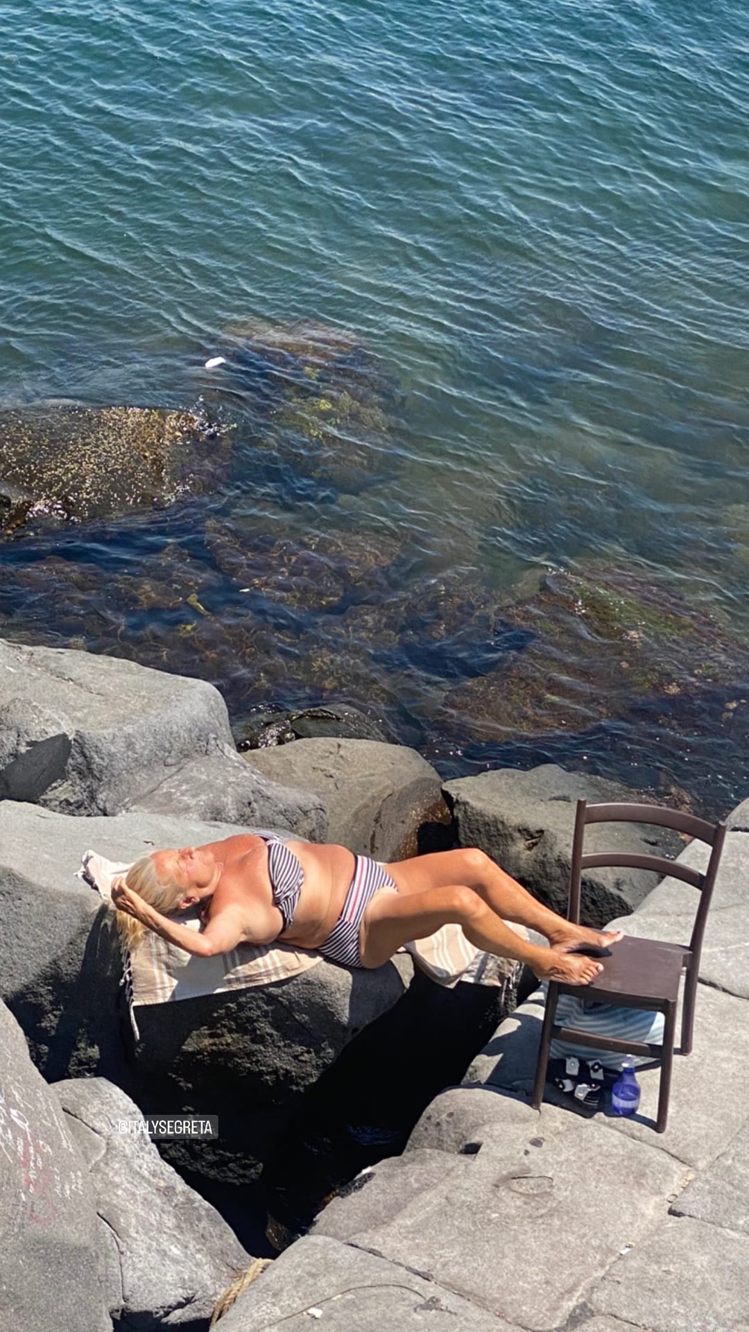 Sunbathing on Naples' volcanic rocks