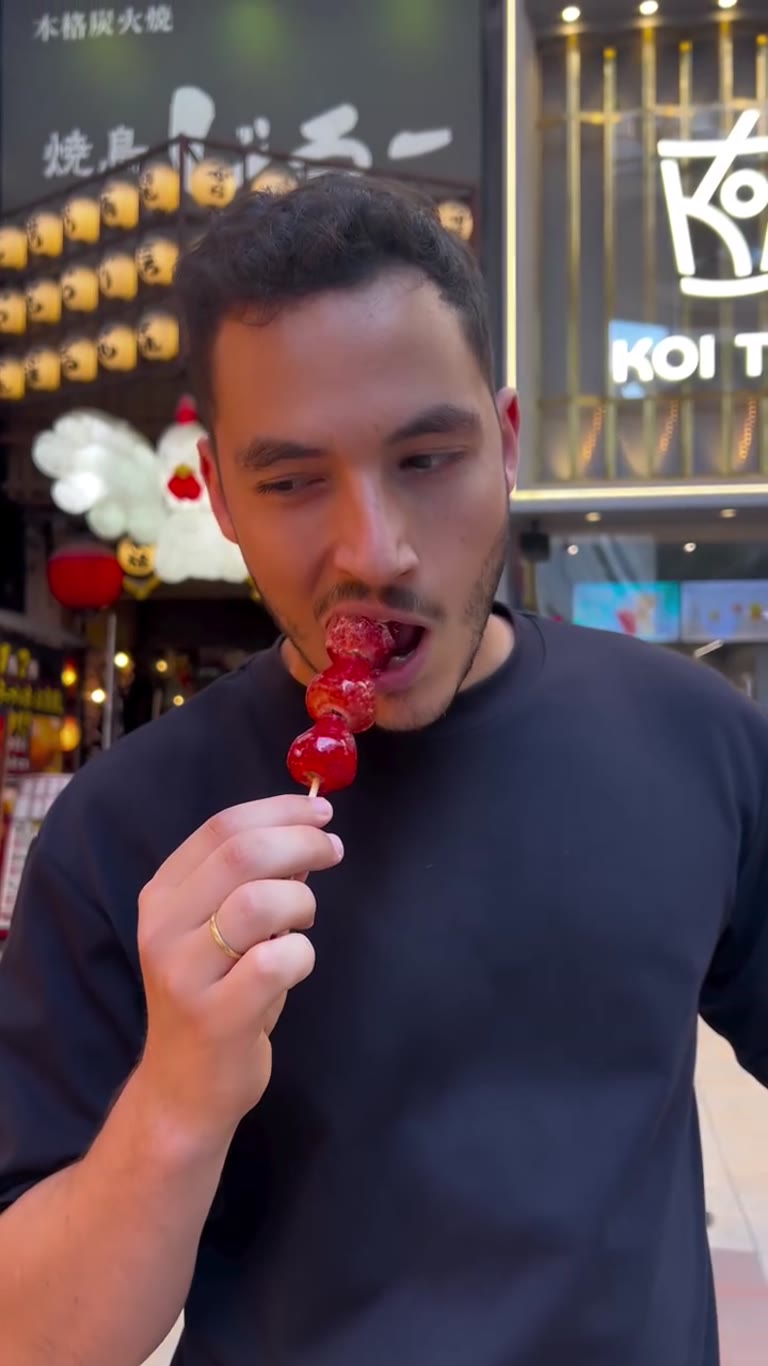 Candied strawberry skewer on an Osaka street