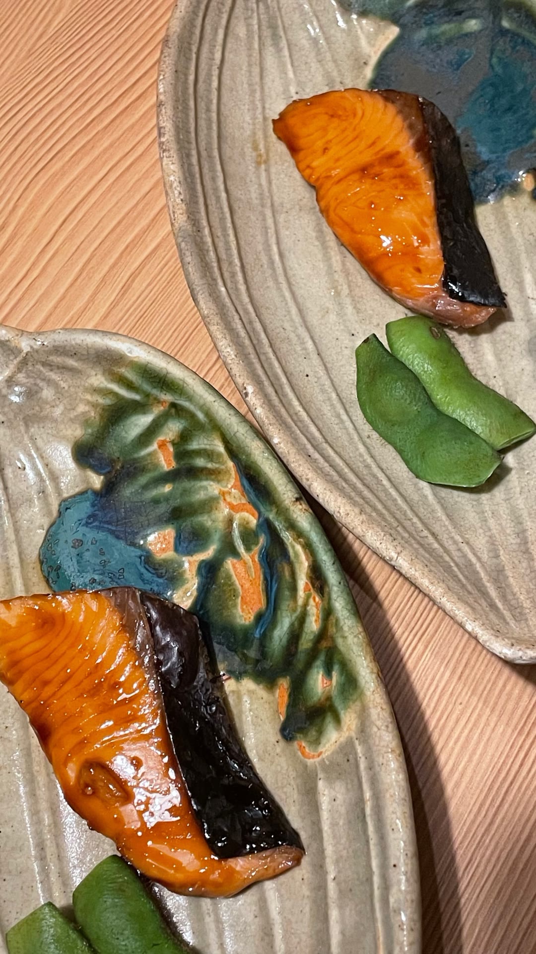 Glazed fish course on ceramic plates in Japan