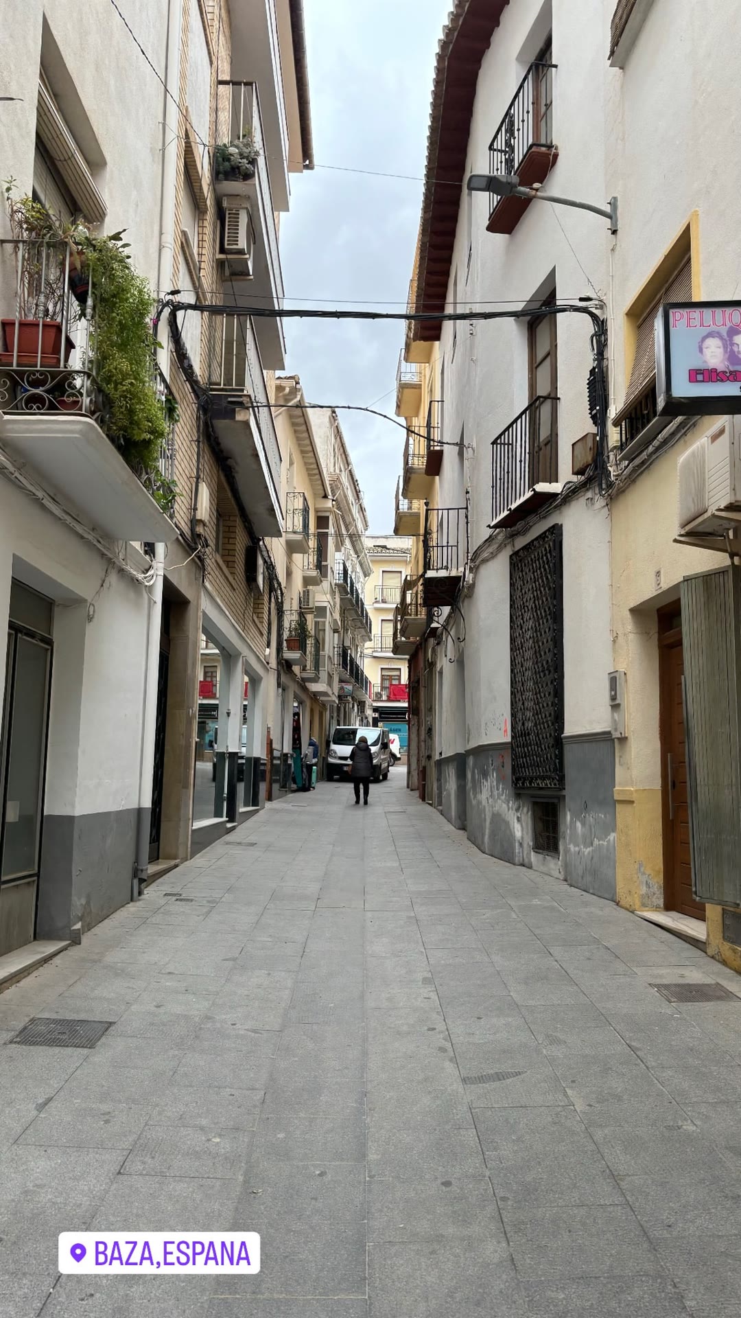 Walking a narrow street in Baza, Granada