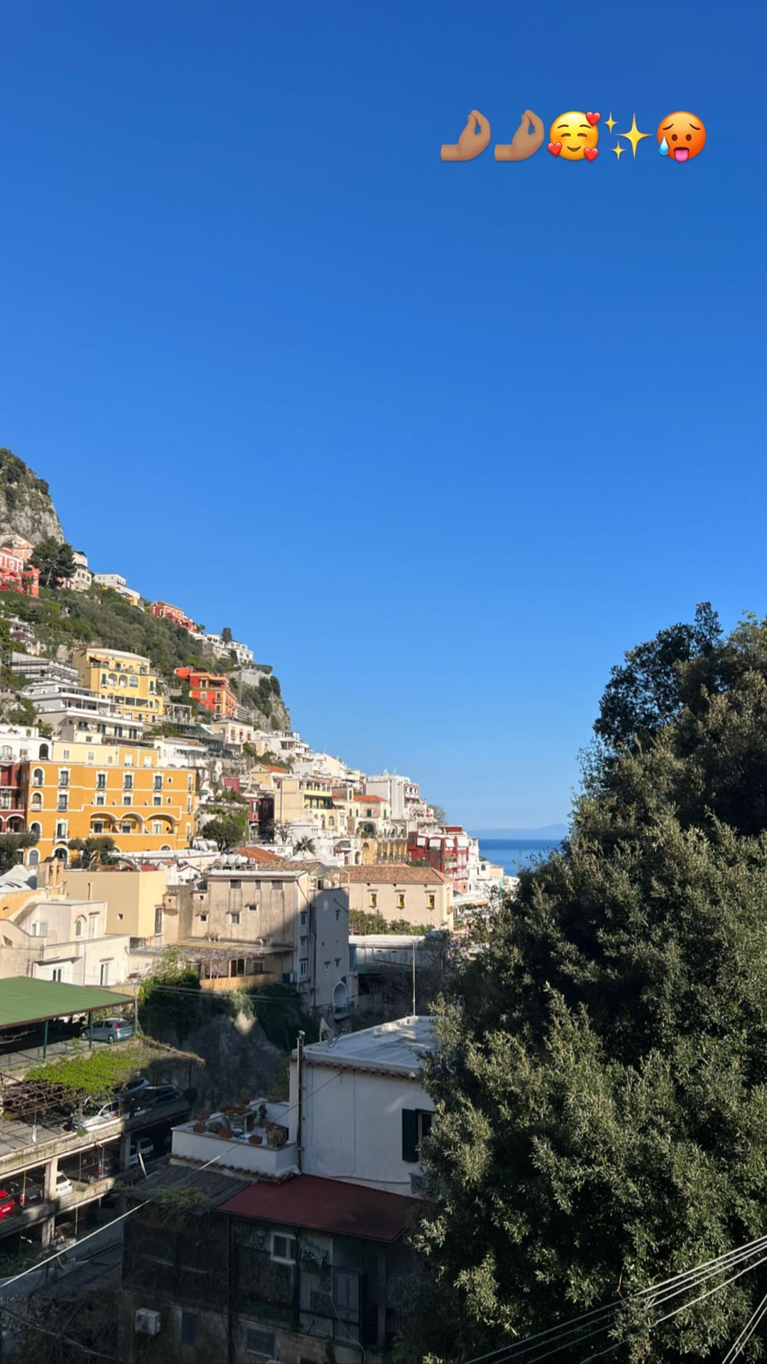 Positano's cliffside houses under blue sky