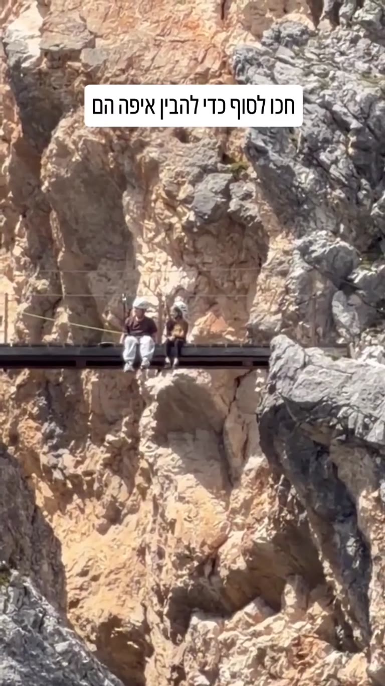 Kids Chatting on a Via Ferrata Bridge in the Dolomites