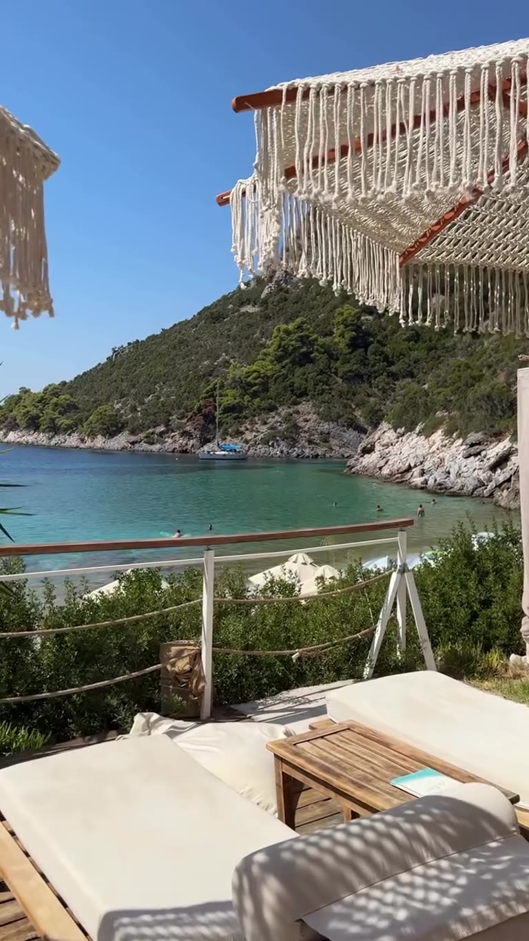 Apanemo beach bar sunbeds over a Skopelos cove