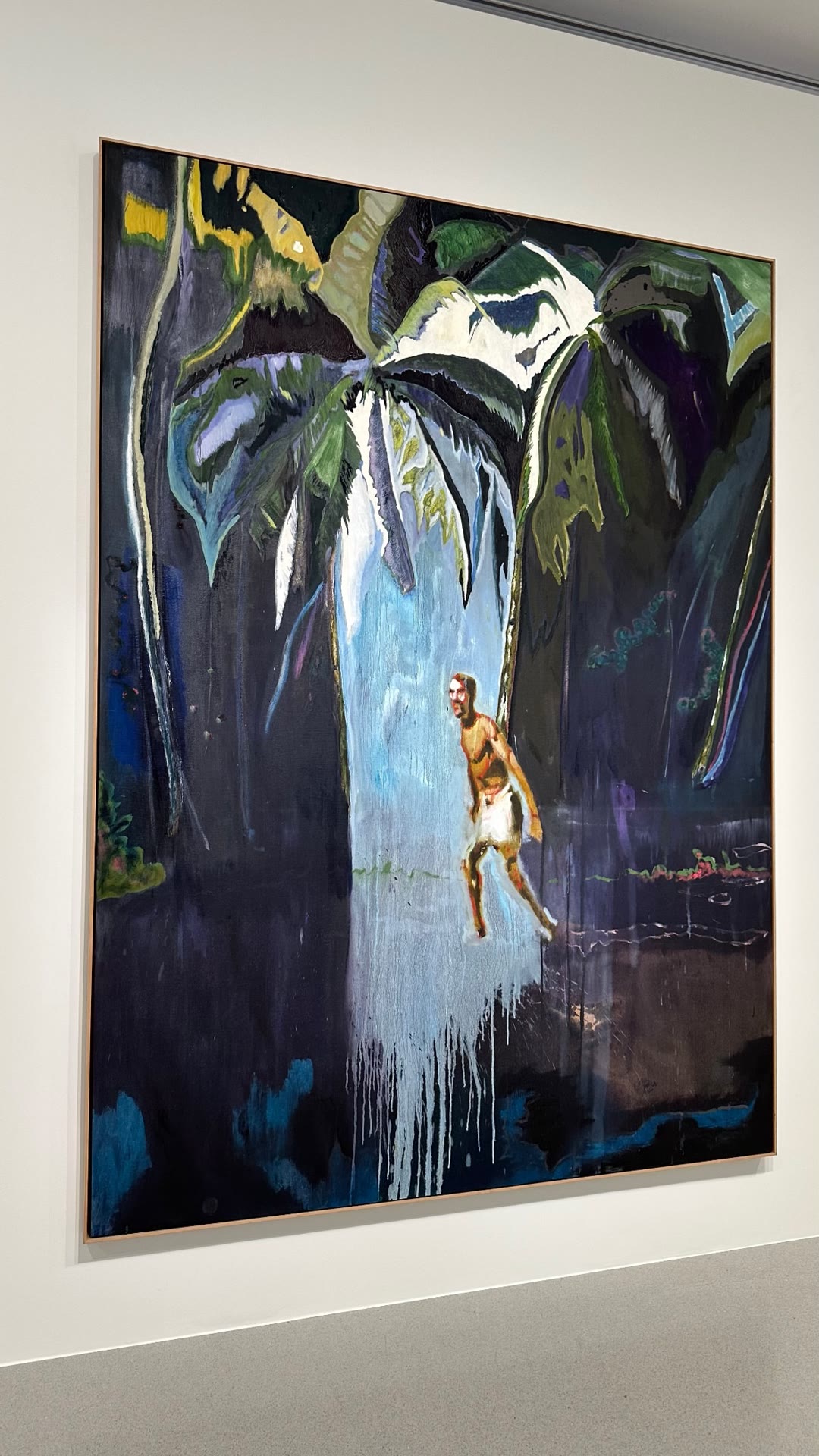 Painting in a museum: figure under palm trees