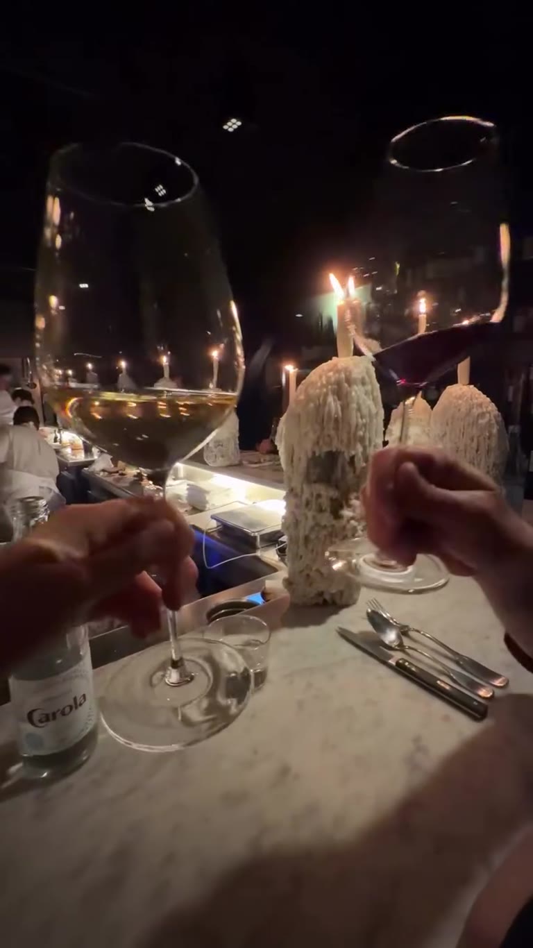 Candlelit dinner toast in Paris