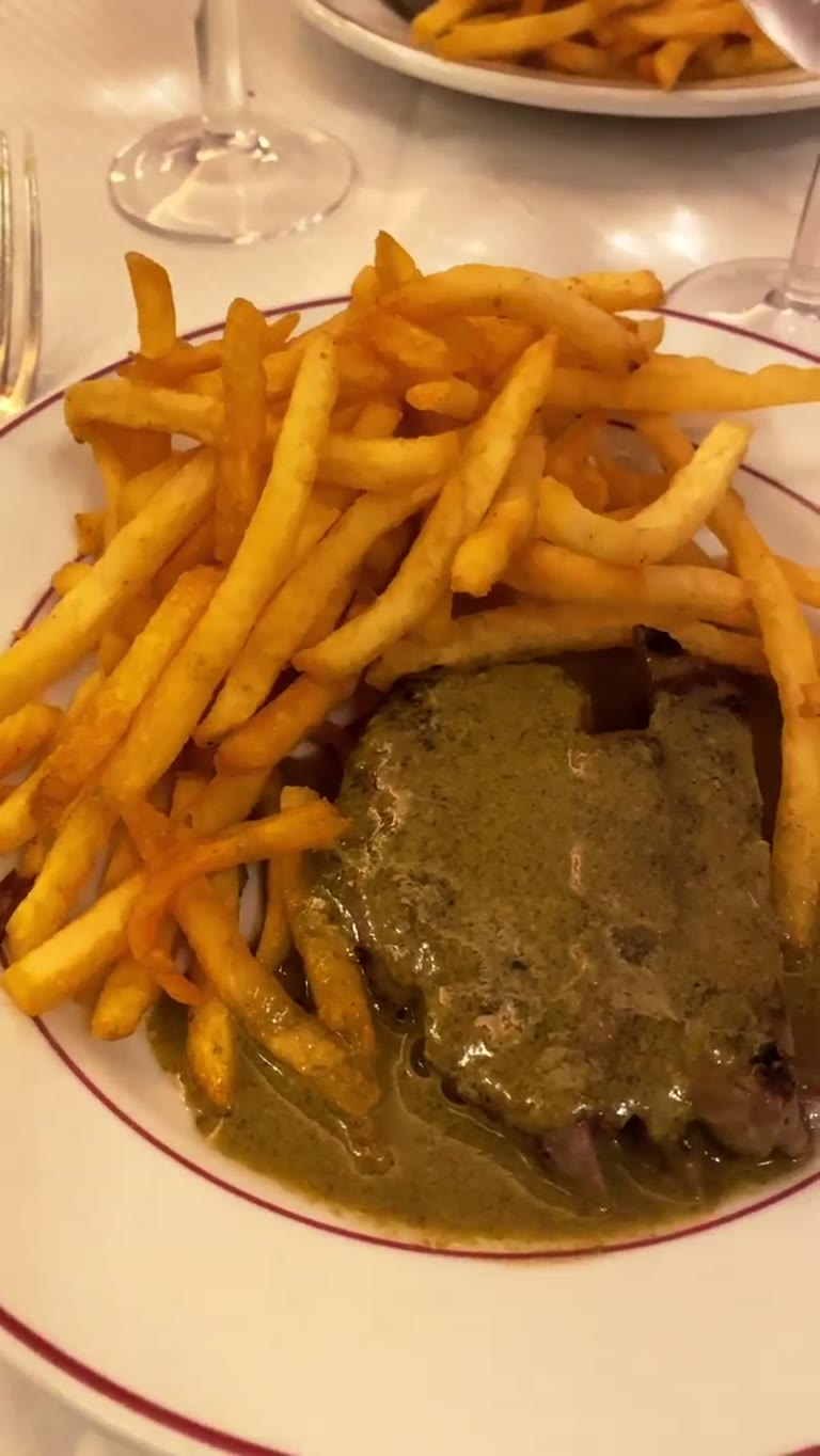Steak frites with green sauce in Paris