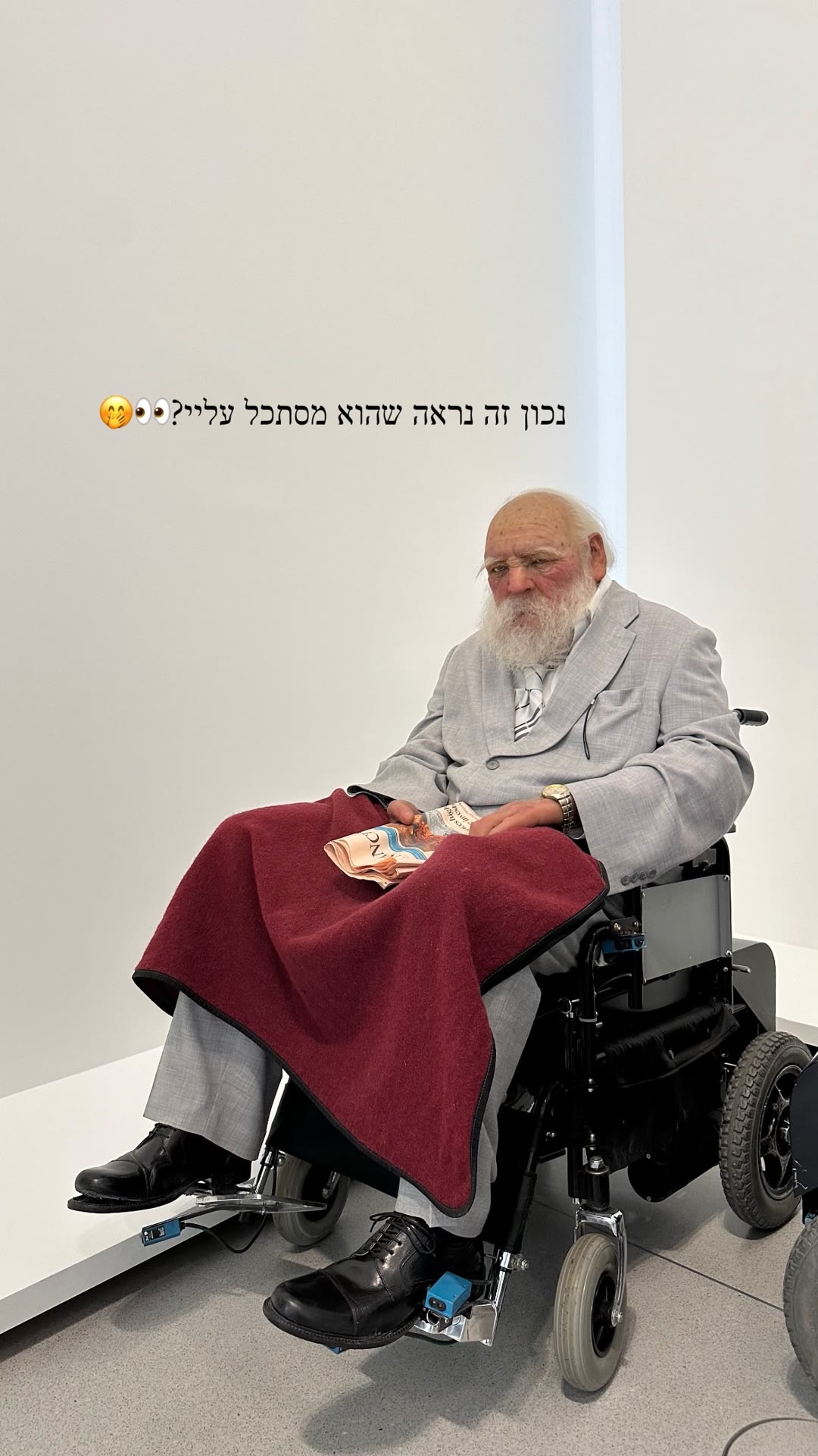 Hyperrealistic wheelchair sculpture at a museum
