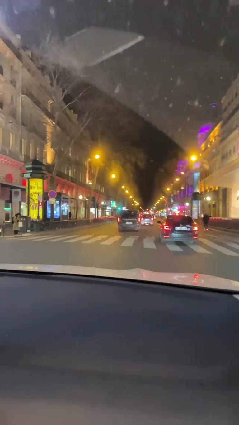 Night drive past Printemps on Boulevard Haussmann