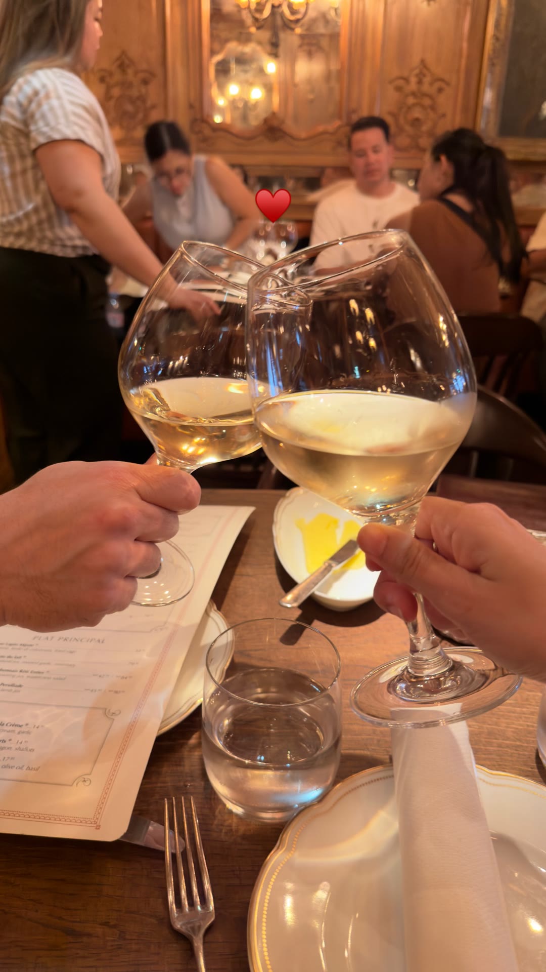 Cheers over white wine at a Paris bistro