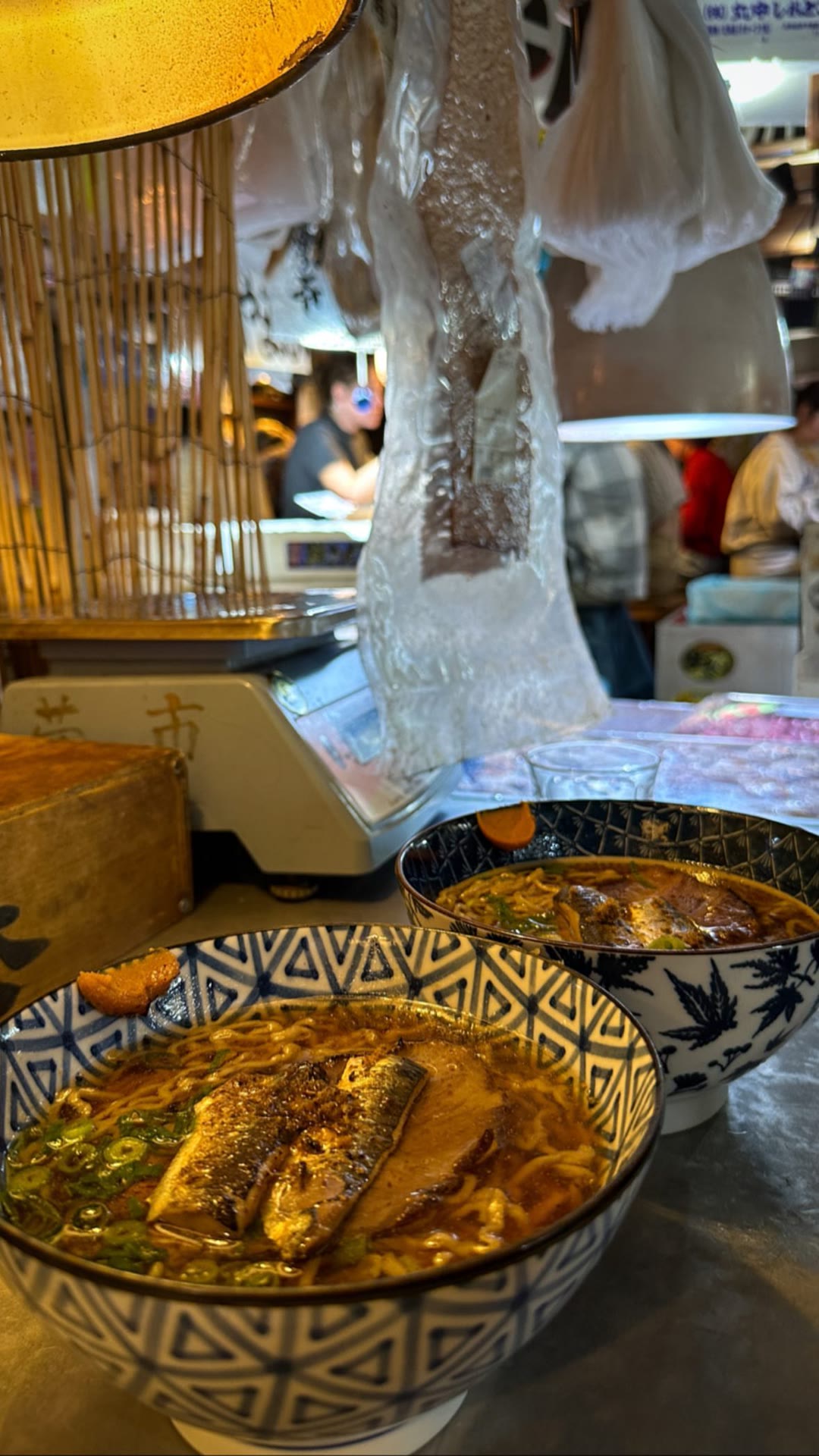 Two bowls of fish ramen at a Japanese market stall
