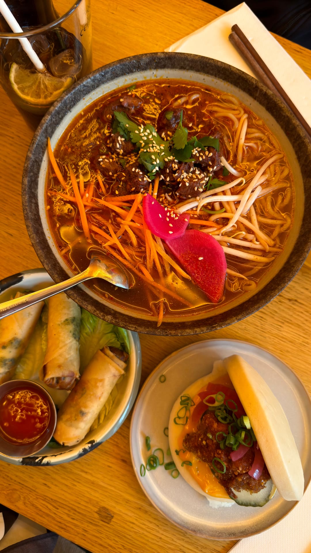 Asian noodle soup, bao and spring rolls in Paris