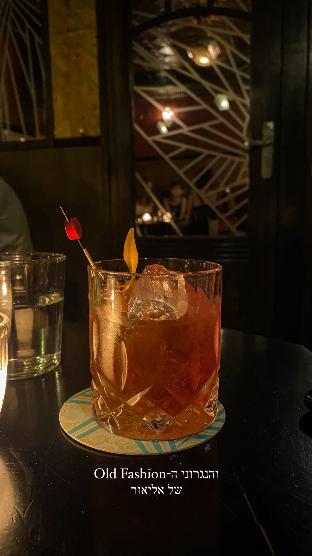 Elior's Old Fashioned at a dark cocktail bar