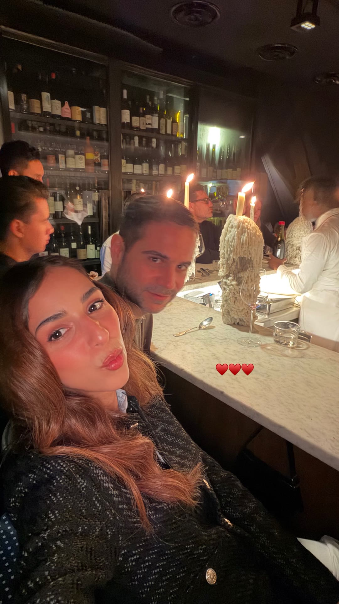 Date night at a candlelit wine bar counter