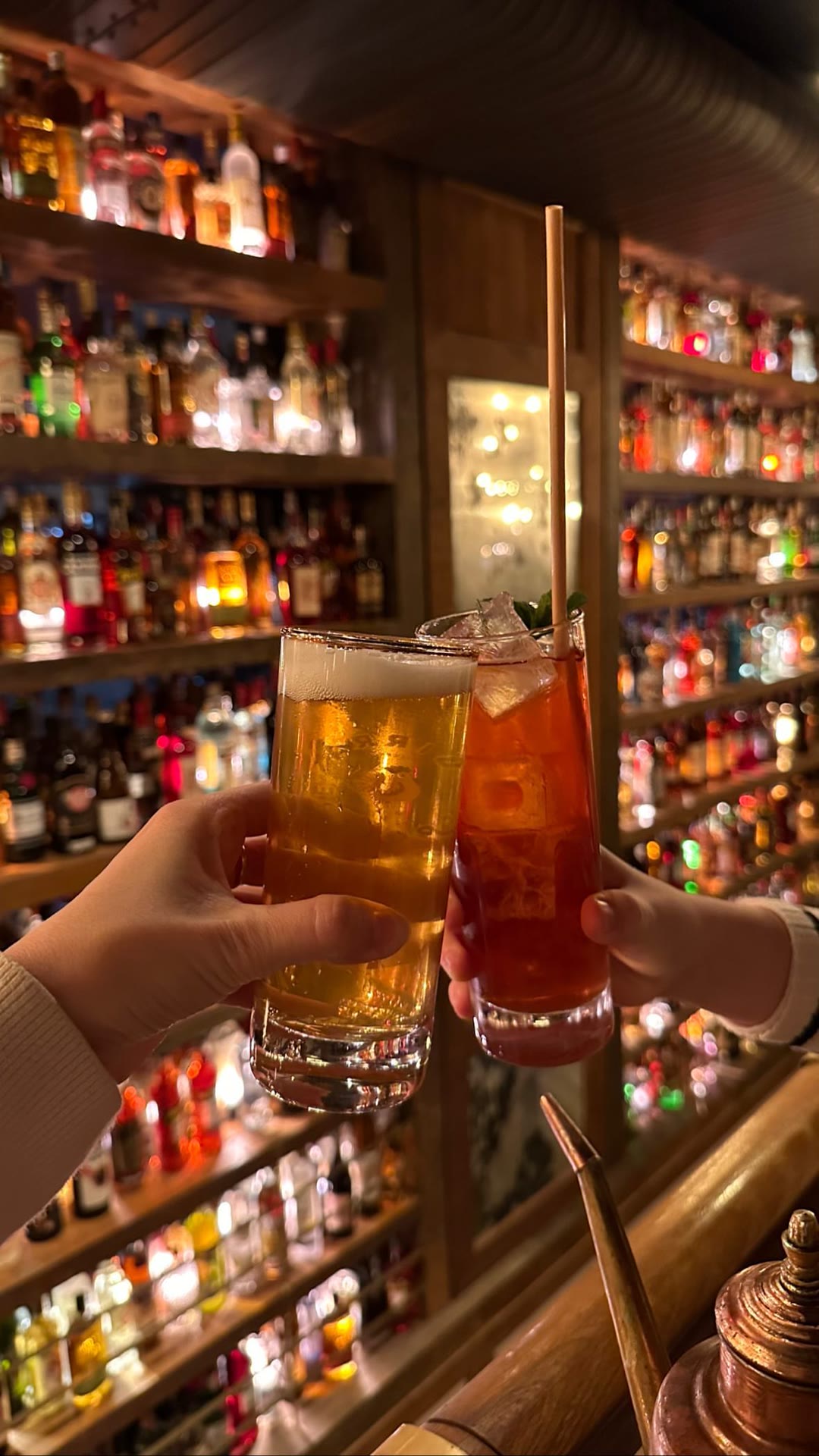 Cocktails at a bottle-lined Paris bar